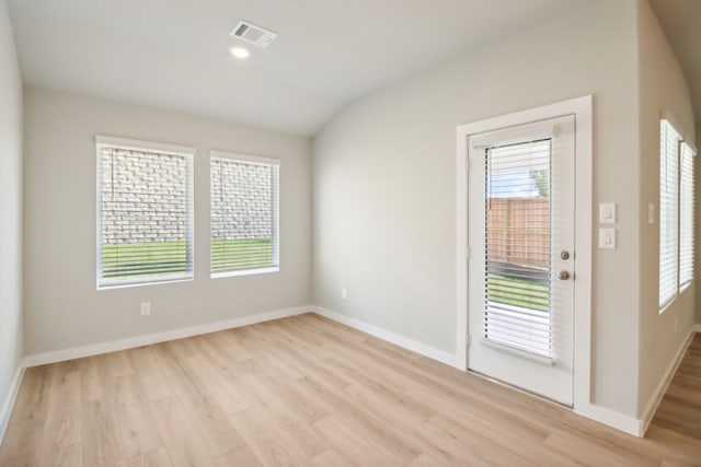 entryway with light hardwood / wood-style flooring and vaulted ceiling