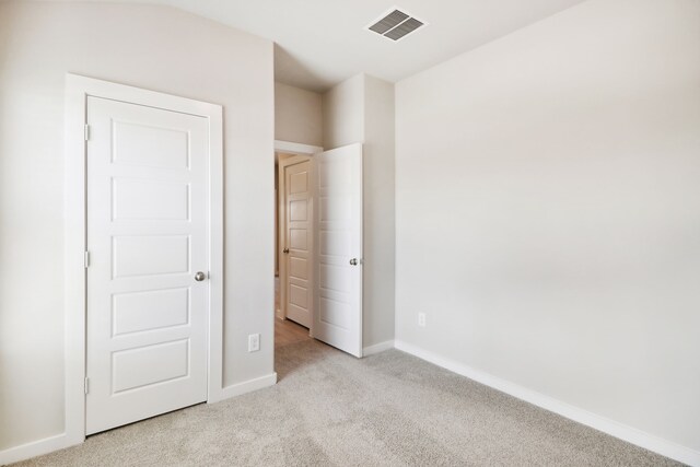 unfurnished bedroom featuring light colored carpet