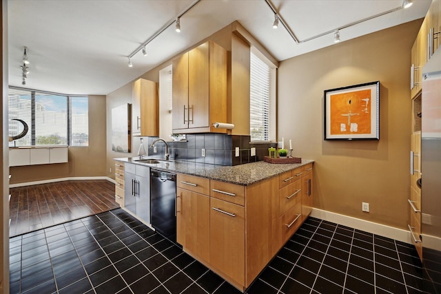 kitchen featuring sink, dark tile patterned floors, light stone countertops, and dishwasher