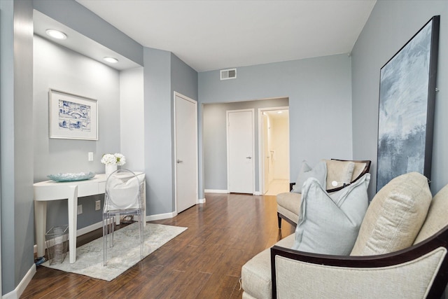 sitting room with dark wood-type flooring