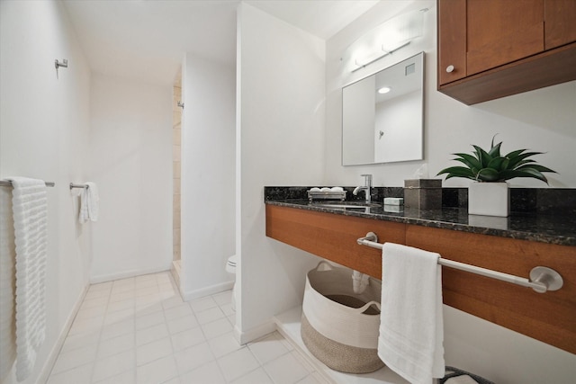 bathroom with vanity, toilet, and walk in shower