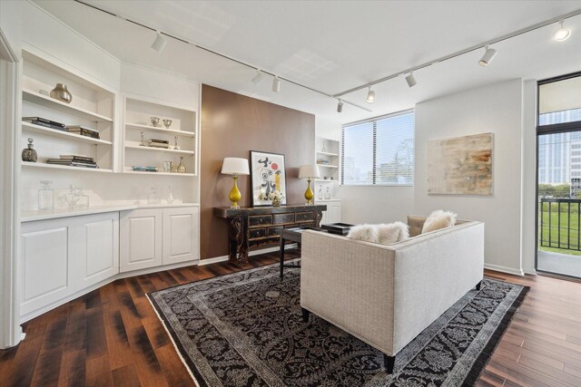 living room with dark hardwood / wood-style floors and built in features