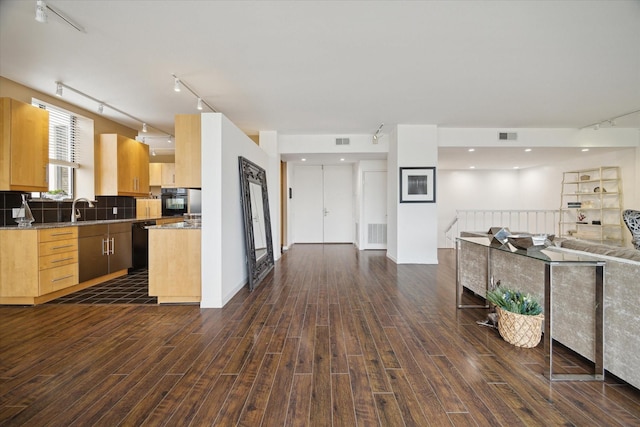 kitchen featuring sink, tasteful backsplash, light brown cabinets, dark hardwood / wood-style flooring, and black appliances