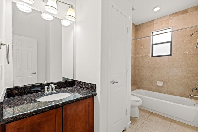 bathroom featuring toilet, bathtub / shower combination, vanity, and tile patterned floors