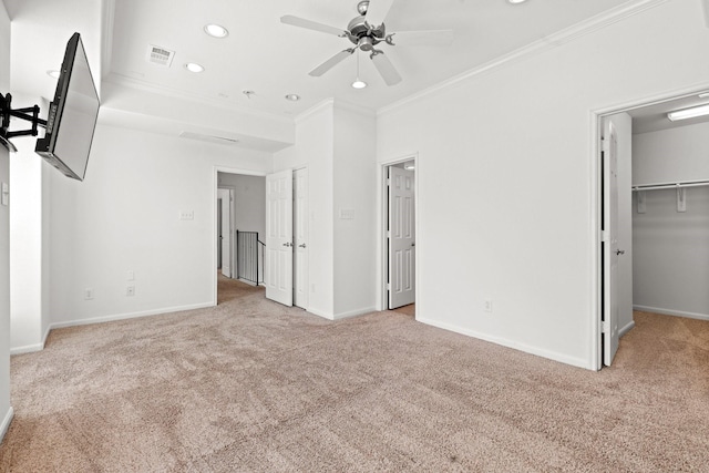 unfurnished bedroom with recessed lighting, carpet, visible vents, crown molding, and baseboards