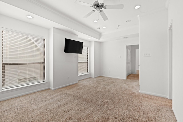 interior space featuring carpet flooring, a tray ceiling, baseboards, recessed lighting, and ornamental molding