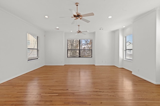 empty room featuring a wealth of natural light, recessed lighting, and ornamental molding