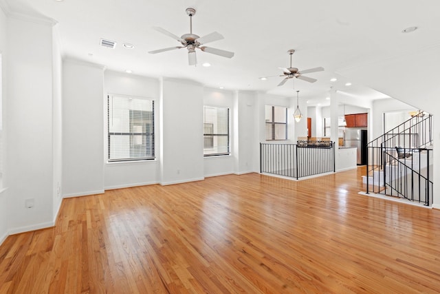 unfurnished living room featuring ornamental molding, a ceiling fan, visible vents, and recessed lighting