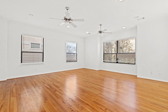 empty room featuring ceiling fan, baseboards, visible vents, and light wood-style flooring