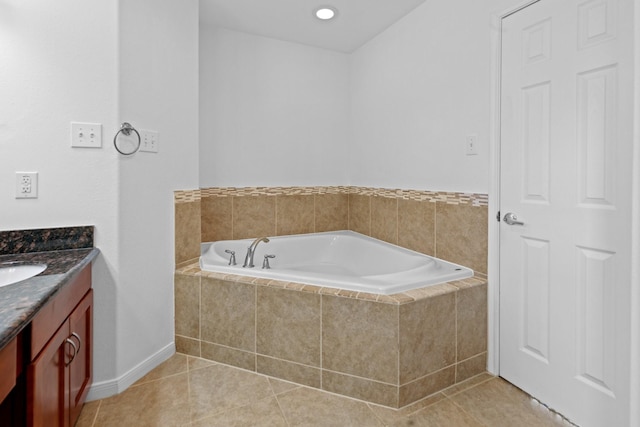 full bath with a garden tub, vanity, tile patterned floors, and baseboards