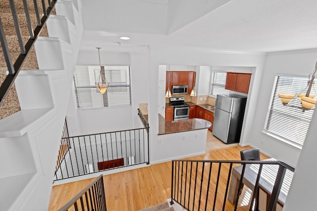 staircase featuring baseboards and wood finished floors