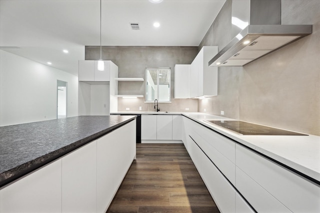 kitchen featuring white cabinetry, black electric stovetop, decorative light fixtures, and extractor fan