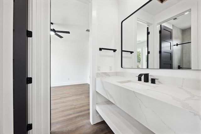 bathroom featuring vanity, hardwood / wood-style floors, and ceiling fan