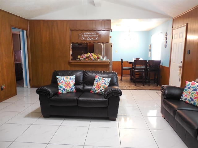 living room with light tile patterned flooring, wooden walls, and lofted ceiling with beams