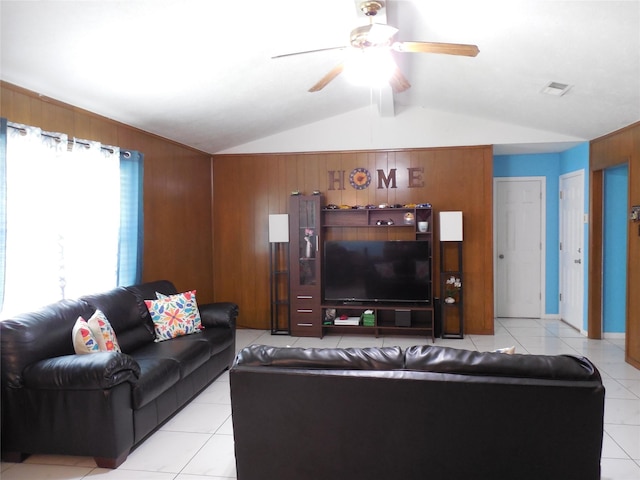 tiled living room featuring vaulted ceiling with beams, ceiling fan, and wood walls