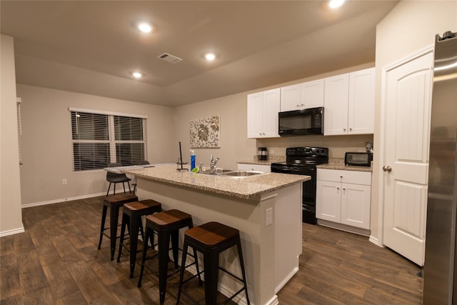 kitchen featuring white cabinetry, sink, a center island with sink, and black appliances