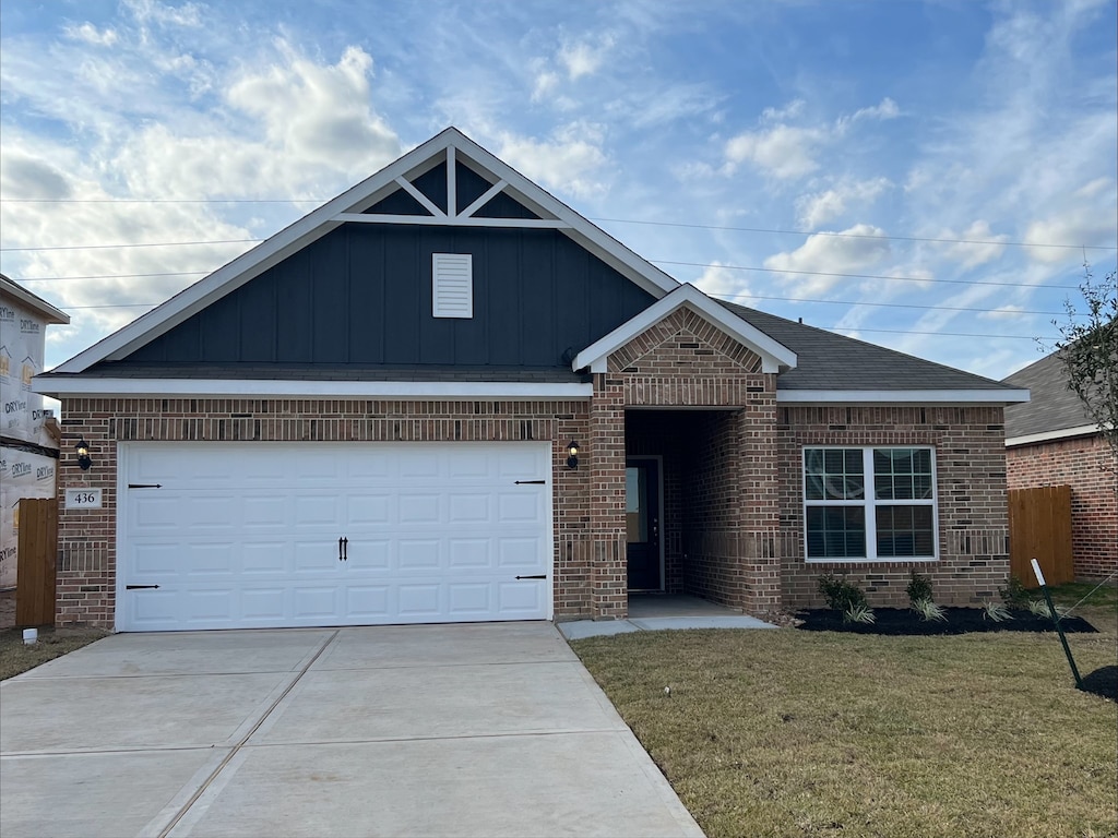 view of front of house with a garage and a front yard