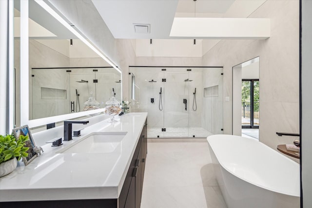 bathroom featuring vanity, independent shower and bath, and tile patterned flooring