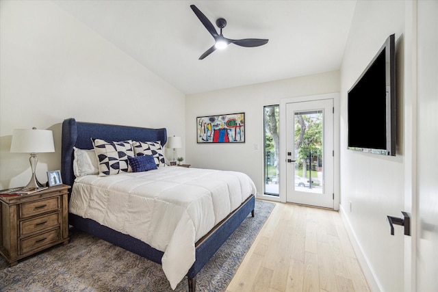 bedroom with hardwood / wood-style flooring, ceiling fan, vaulted ceiling, and access to outside