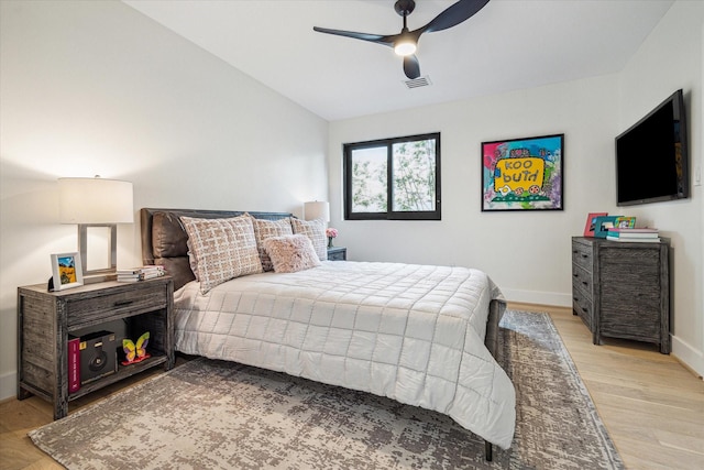 bedroom with vaulted ceiling, ceiling fan, and light hardwood / wood-style floors