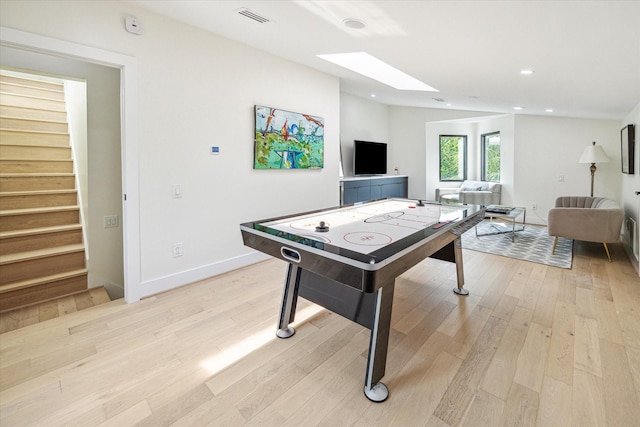 playroom featuring light hardwood / wood-style floors and a skylight