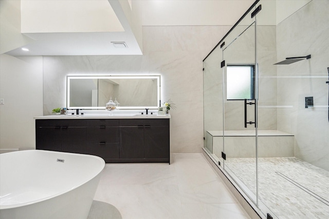 bathroom with vanity, separate shower and tub, and tile walls