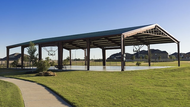 view of home's community with a yard and basketball hoop