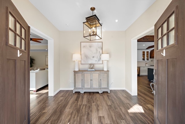 corridor featuring a notable chandelier and dark hardwood / wood-style flooring