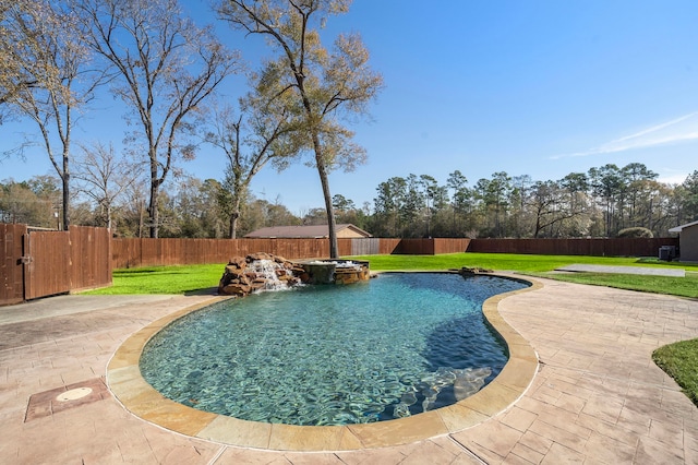 view of swimming pool featuring a patio area, pool water feature, and a lawn