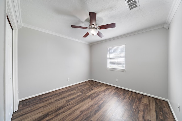 empty room with crown molding, dark wood-type flooring, ceiling fan, and a textured ceiling