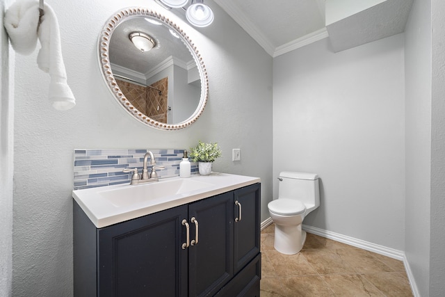 bathroom featuring tasteful backsplash, ornamental molding, vanity, and toilet