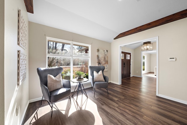 sitting room featuring dark wood-type flooring, a chandelier, and vaulted ceiling with beams