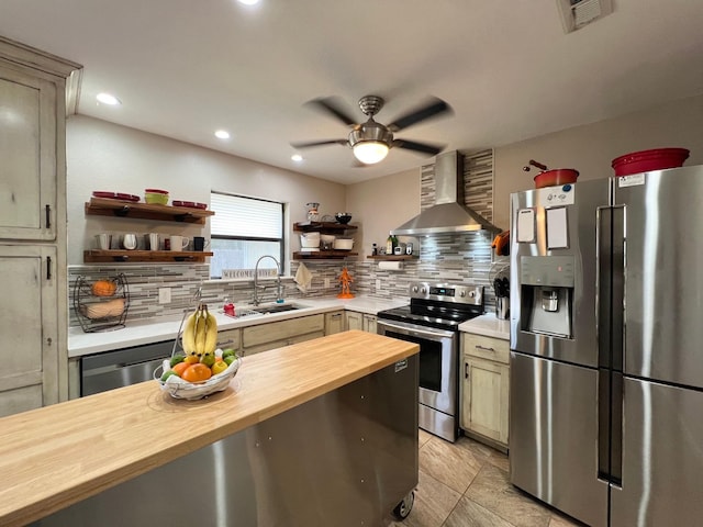 kitchen featuring appliances with stainless steel finishes, ventilation hood, butcher block counters, sink, and backsplash