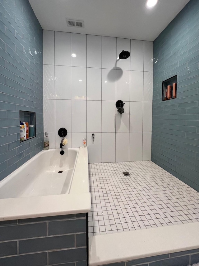 bathroom with tile walls and walk in shower