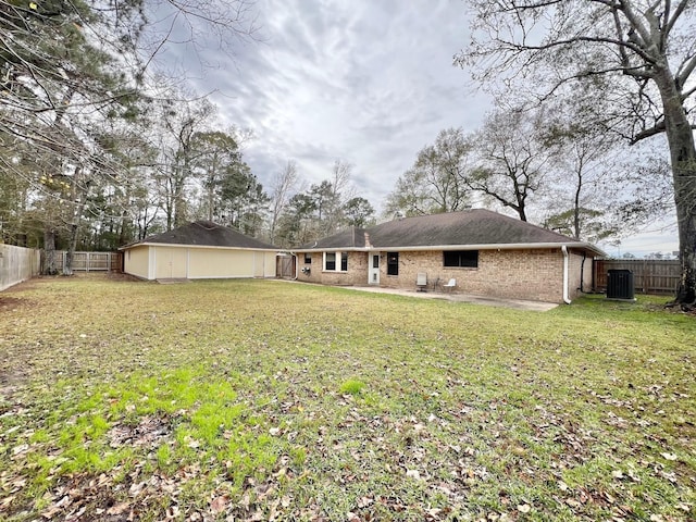 back of house featuring a patio, a lawn, and central air condition unit