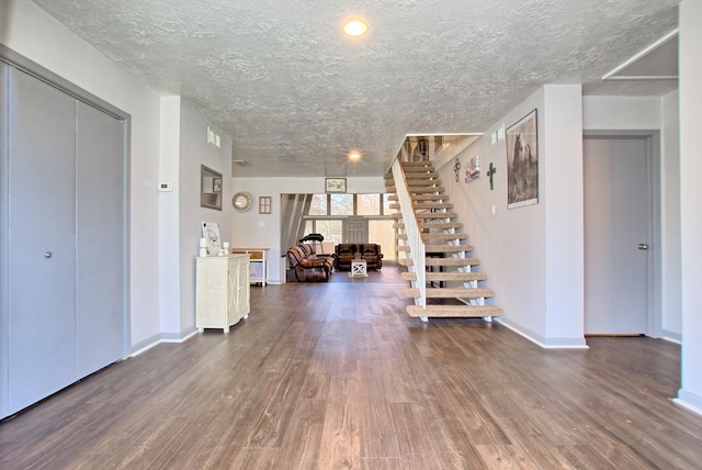 interior space with dark hardwood / wood-style floors and a textured ceiling