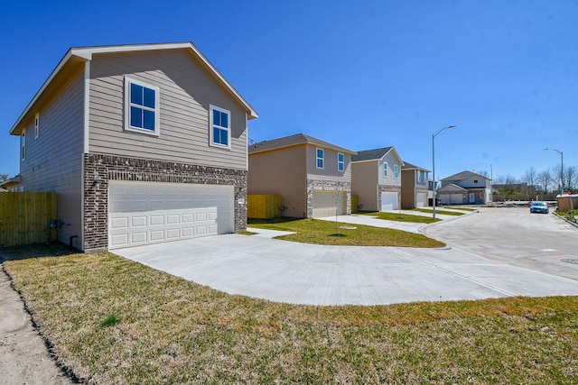 view of front of property featuring a garage and a front lawn