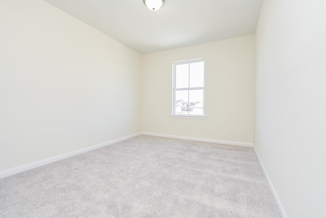 unfurnished room with light carpet