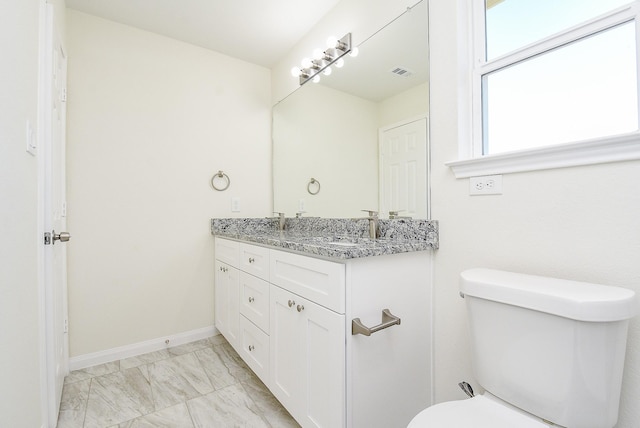 bathroom featuring vanity and toilet