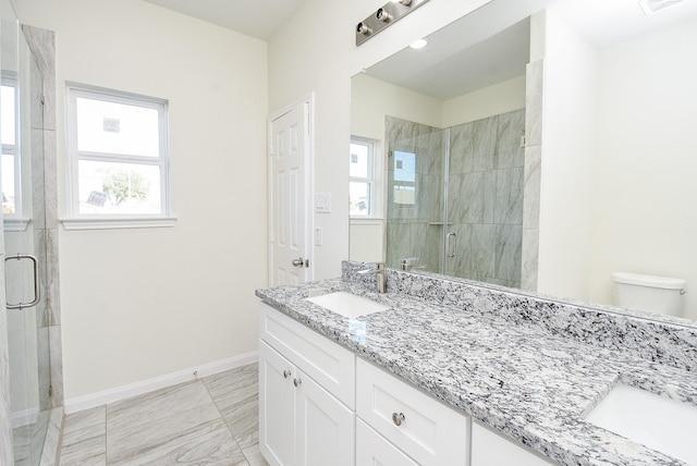 bathroom featuring vanity, toilet, and walk in shower