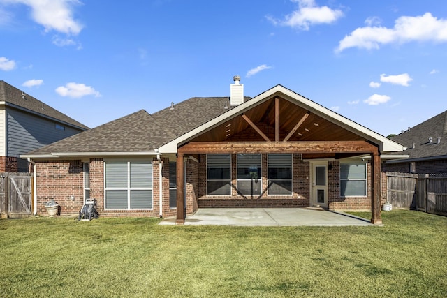 rear view of property with a patio area and a lawn