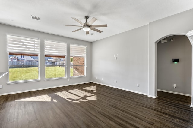 spare room with dark wood-type flooring and ceiling fan