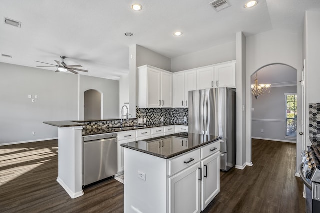 kitchen featuring white cabinetry, stainless steel appliances, sink, and a kitchen island