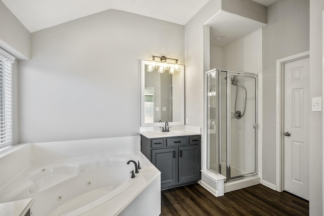 bathroom with hardwood / wood-style floors, vanity, a healthy amount of sunlight, vaulted ceiling, and separate shower and tub