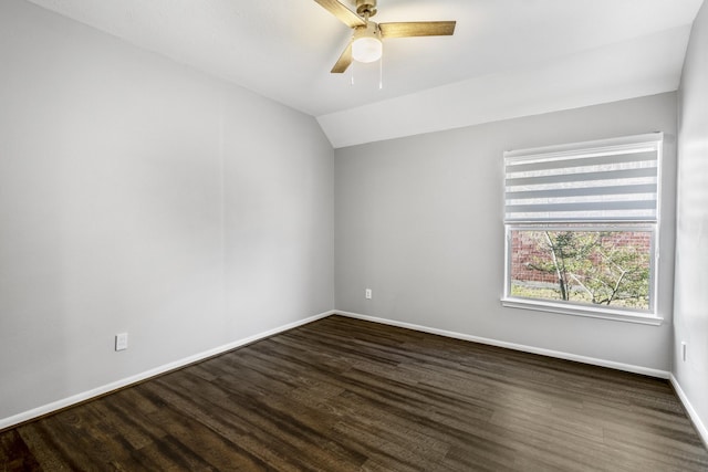 spare room featuring vaulted ceiling, dark wood-type flooring, and ceiling fan