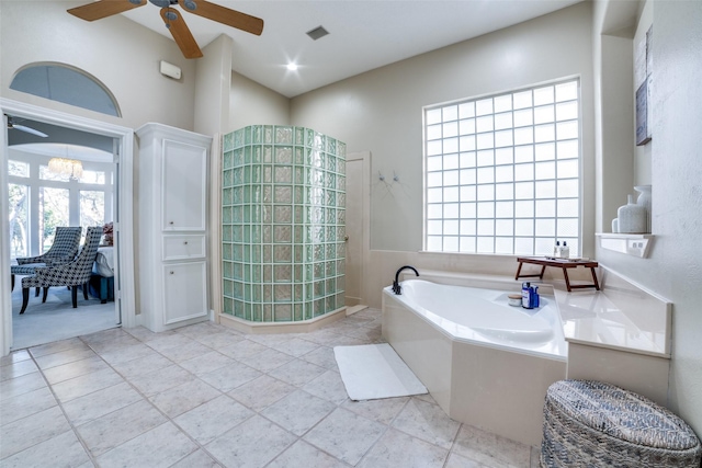 bathroom featuring ceiling fan, a healthy amount of sunlight, and shower with separate bathtub