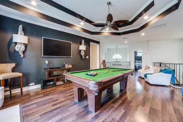 recreation room featuring a raised ceiling, crown molding, dark wood-type flooring, and pool table