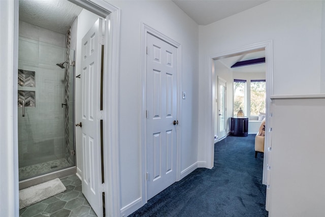 hall with dark colored carpet