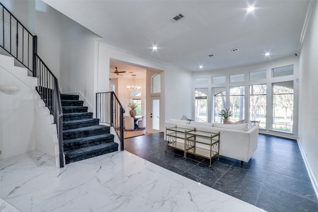 living room with an inviting chandelier and ornamental molding