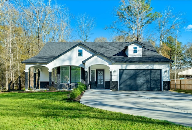 view of front of property featuring a porch, a garage, and a front lawn